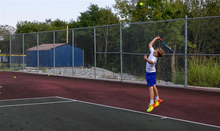 A tennis player hits the ball